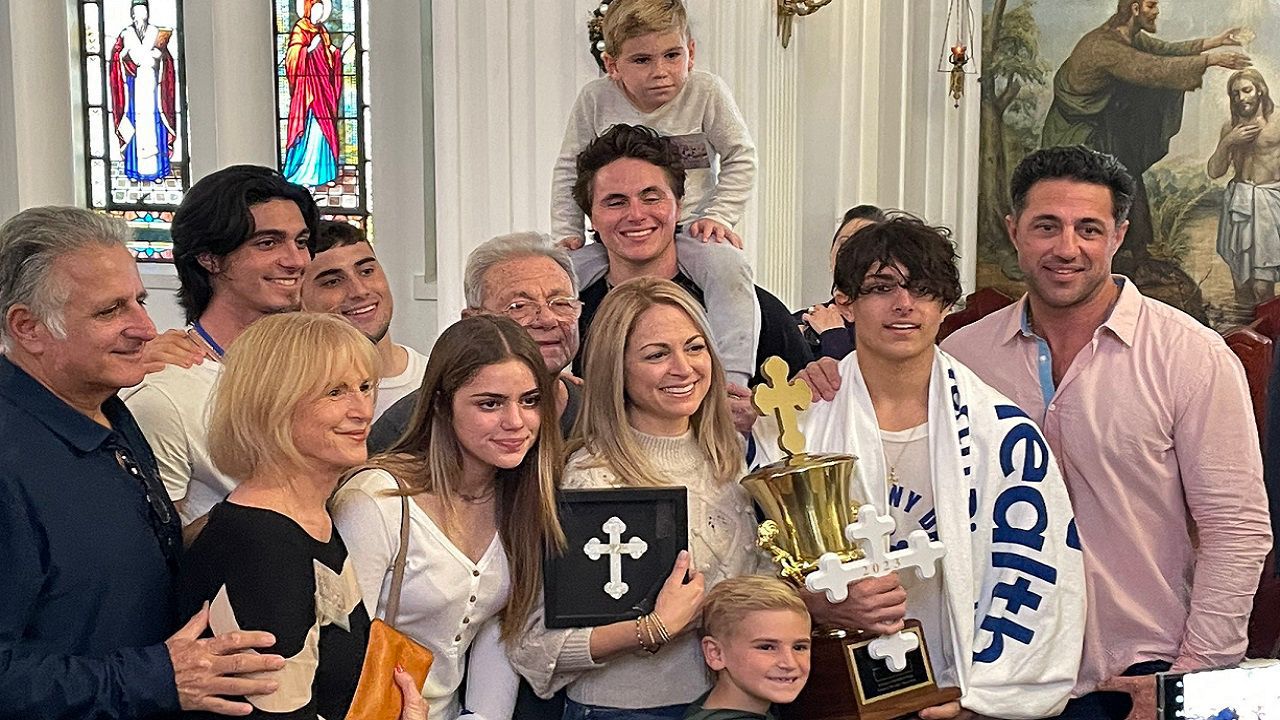 George Stamas and his family after he retrieved the cross in 2023. (Spectrum News/Nick Popham)