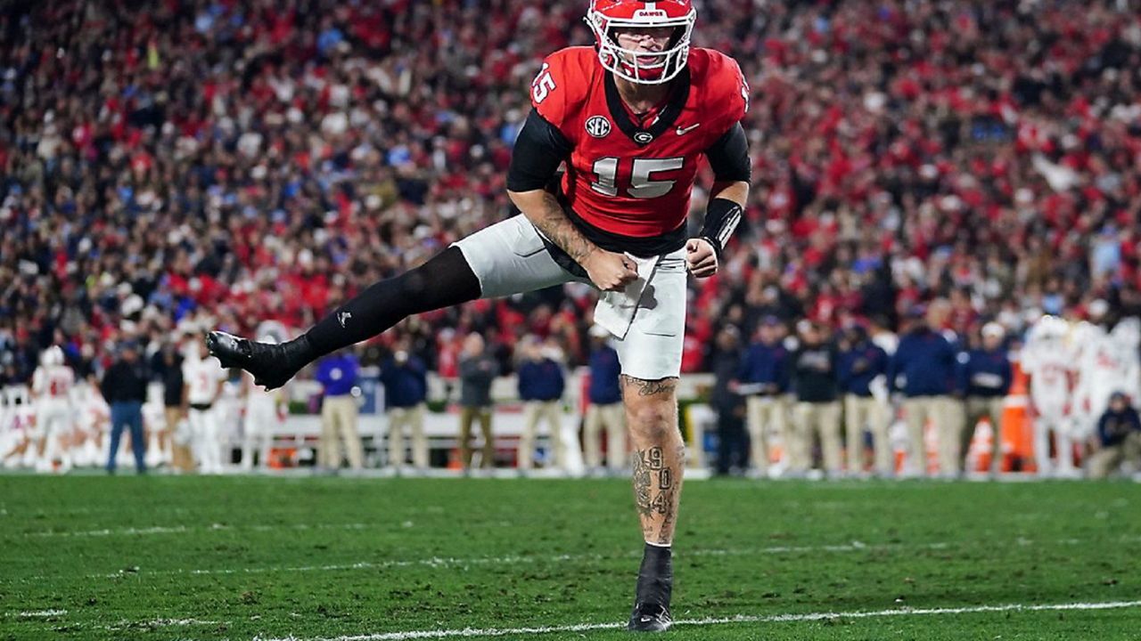 Georgia quarterback Carson Beck (15) reacts after a Georgia touchdown during the first half of an NCAA college football game against Mississippi, Saturday, Nov. 11, 2023, in Athens, Ga. (AP Photo/John Bazemore)