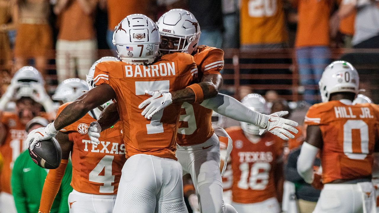 Texas defensive back Jahdae Barron (7) celebrates his interception with Texas defensive back Gavin Holmes (9) during the first half of an NCAA college football game against Georgia in Austin, Texas, Saturday, Oct. 19, 2024. (AP Photo/Rodolfo Gonzalez)