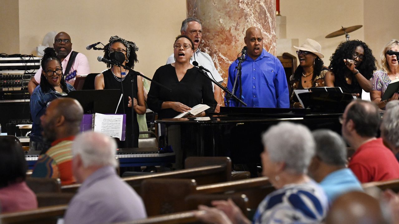 The Gesu Choir is cheered on by the congregation as they sing during Mass on Sunday, June 18, 2023 at Gesu Catholic Church in Detroit.