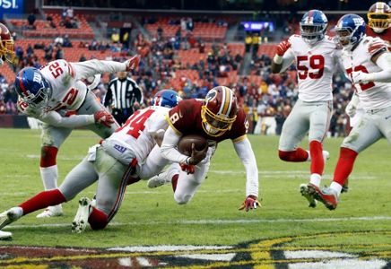 Washington Redskins quarterback Mark Sanchez (6) looks for a receiver in  first quarter action during the game against the New York Giants at FedEx  Field in Landover, Maryland on Sunday, December 9