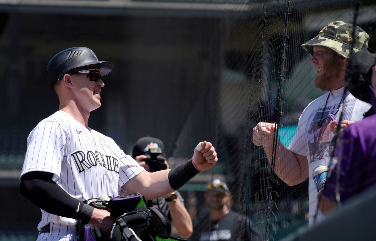 Rockies rook fouls 1st MLB pitch near family, mom gets ball