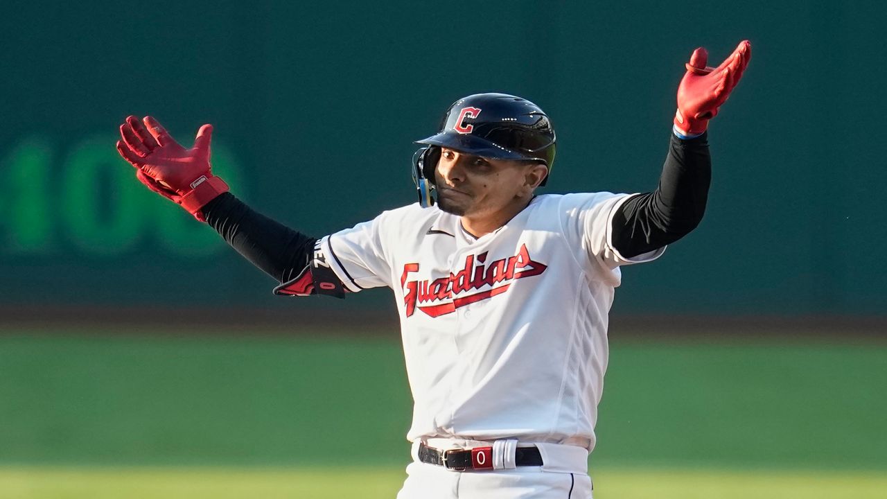 Cleveland Guardians' Andres Gimenez gestures from second base after hitting a double against the Chicago White Sox during the second inning of a baseball game Friday, Aug. 4, 2023, in Cleveland. (AP Photo/Sue Ogrocki)