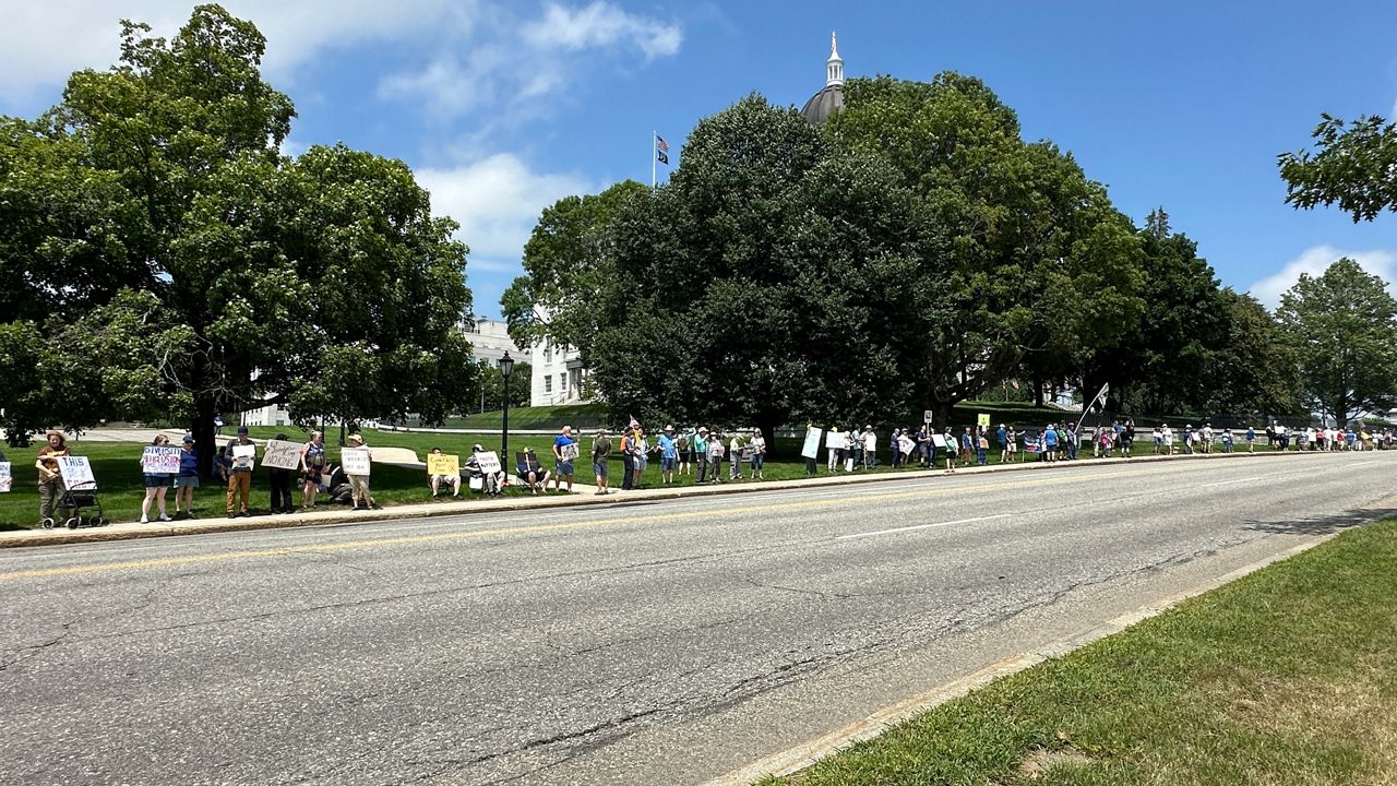 Hundreds of protesters lined the sidewalks around the State House Thursday to protest the Trump administration. (Spectrum News/Susan Cover)