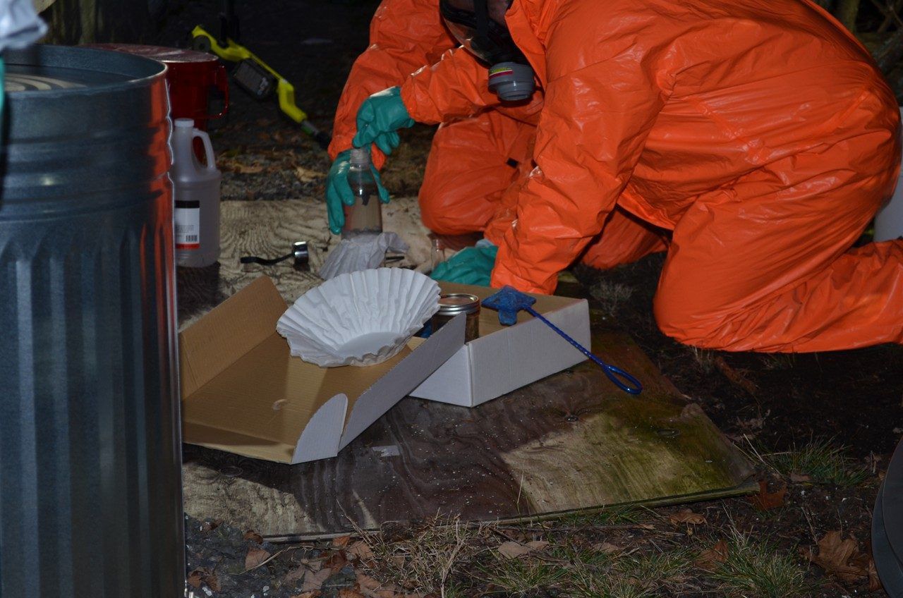 Maine DEA agents collect items police say were used to make methamphetamines outside a Gorham church. (Maine Department of Public Safety)