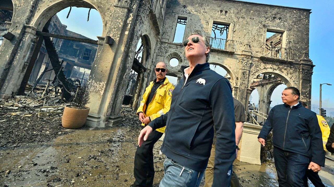 California Governor Gavin Newsom, center, surveys damage in Pacific Palisades with CalFire's Nick Schuler, left, and Senator Alex Padilla, D-Calif., during the Palisades Fire on Jan. 8, 2025, in Pacific Palisades, Calif. (Jeff Gritchen/The Orange County Register via AP)