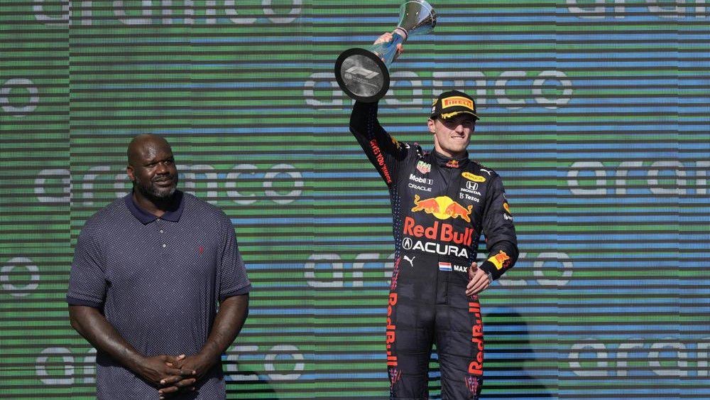 Red Bull driver Max Verstappen, right, of the Netherlands, holds up the winner's trophy as Shaquille O'Neal looks on at the Formula One U.S. Grand Prix auto race at Circuit of the Americas, Sunday, Oct. 24, 2021, in Austin, Texas. (AP Photo/Nick Didlick)
