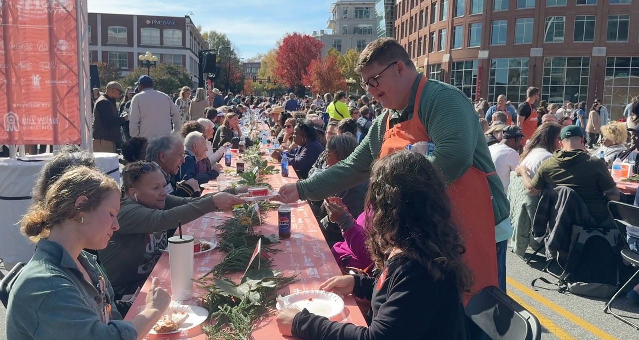 A 'Gratefull GVL' volunteer serves guests