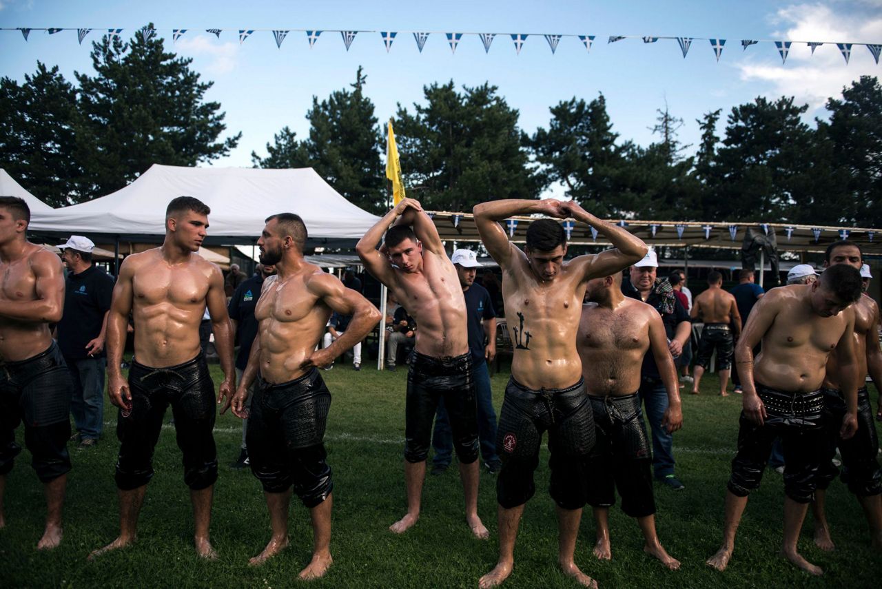 AP PHOTOS Oil wrestling practiced with devotion in Greece