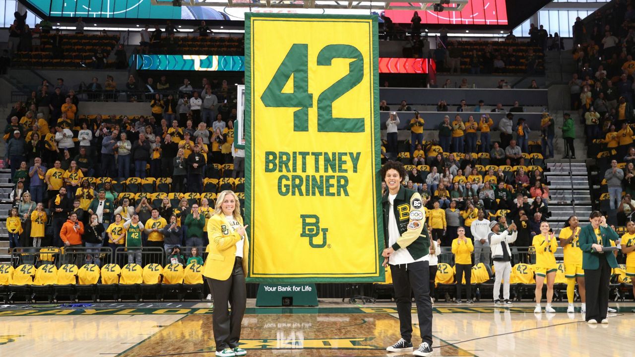 Former Baylor University legend and WNBA star Brittney Griner, right, looks on with Baylor head coach Nicki Collen, left, during her No. 42 jersey retirement ceremony before an NCAA college basketball game against Texas Tech, Sunday, Feb. 18, 2024, in Waco, Texas. (Rod Aydelotte/Waco Tribune-Herald via AP)