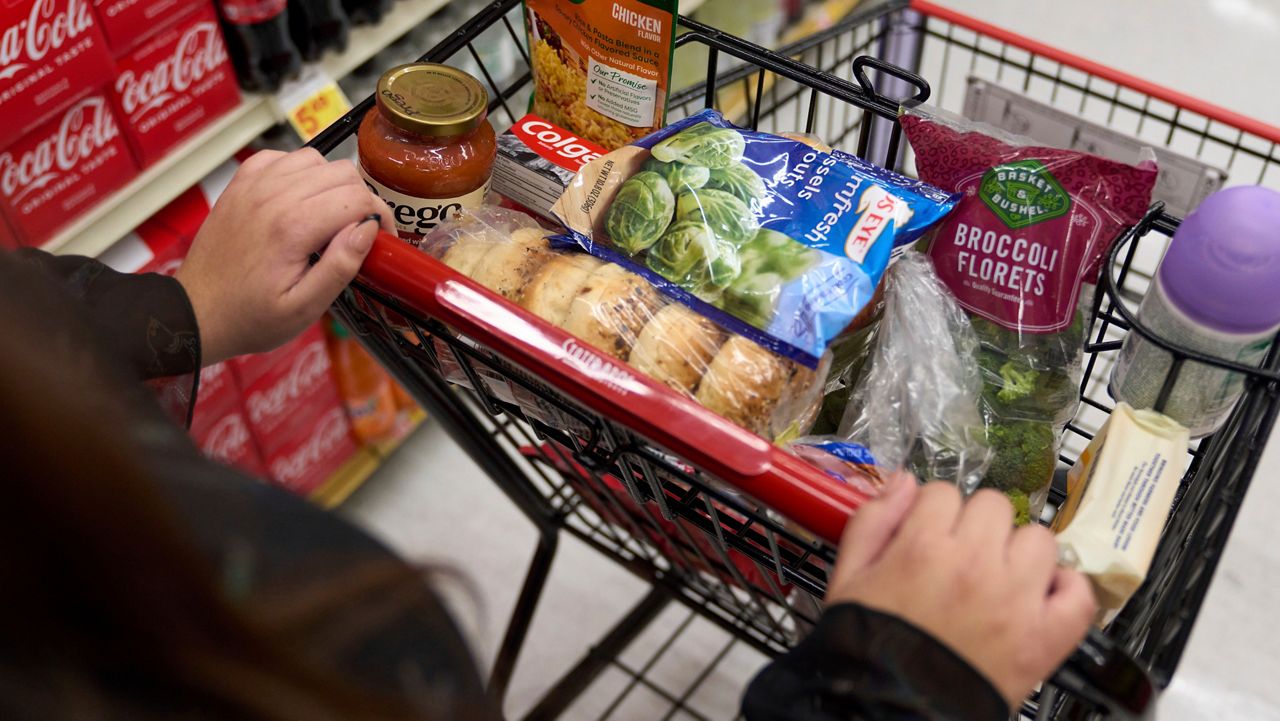 A food shopper pushes a cart of groceries at a supermarket in Bellflower, Calif., on Monday, Feb. 13, 2023. 