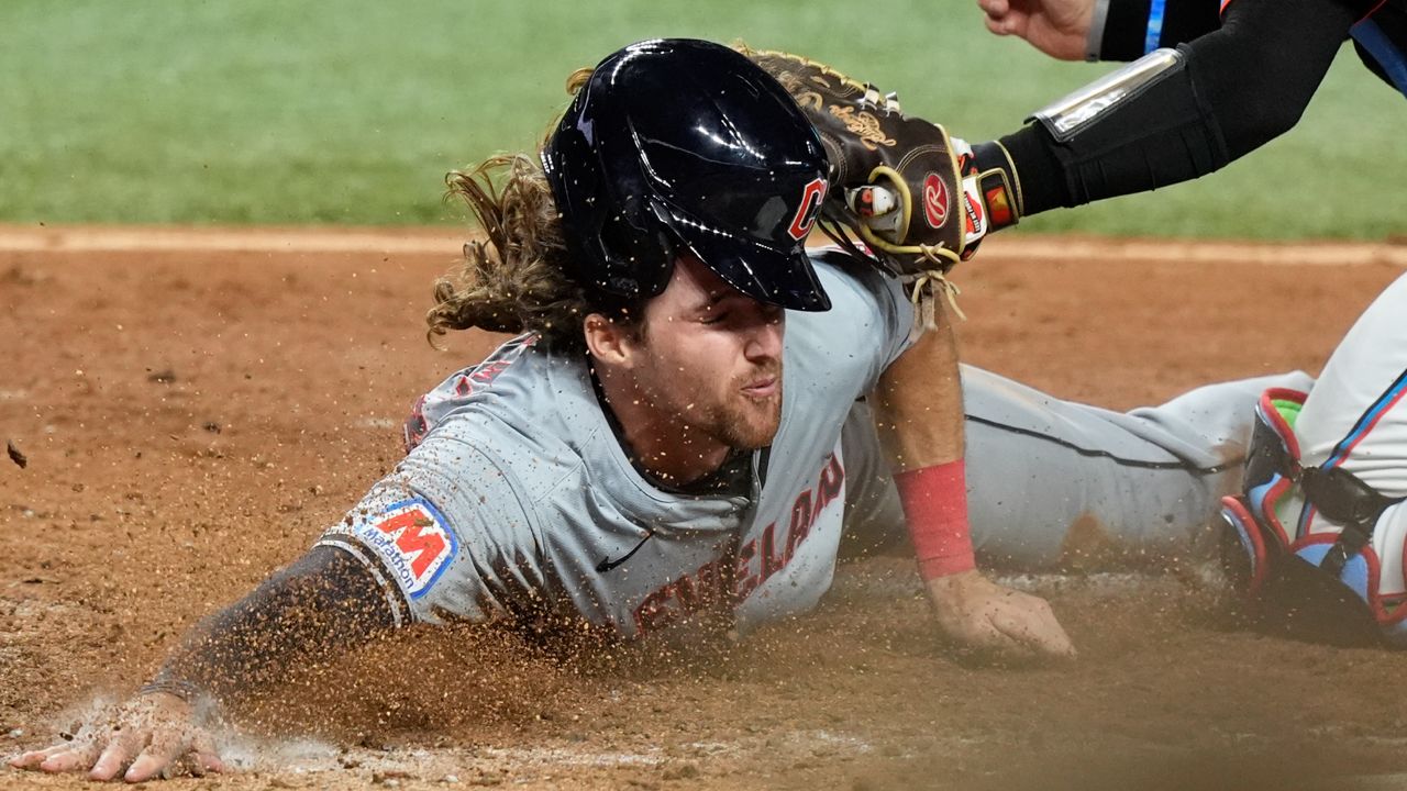 Cleveland Guardians' Daniel Schneemann is tagged out at the plate during the eighth inning of the team's baseball game against the Miami Marlins, Friday, June 7, 2024, in Miami.