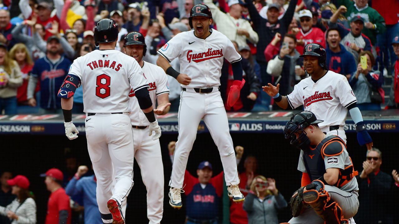 Cleveland Guardians players, from rear left, David Fry, Steven Kwan and Jose Ramirez greet teammate Lane Thomas after Thomas hit a grand slam in the fifth inning during Game 5 of baseball's American League Division Series against the Detroit Tigers, Saturday, Oct. 12, 2024, in Cleveland. 