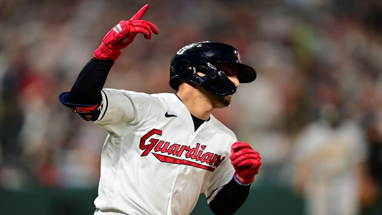 Cleveland Guardians' Andres Gimenez runs to first base on a single that drove in the winning run during the 10th inning of the team's baseball game against the Oakland Athletics, Tuesday, June 20, 2023, in Cleveland. The Guardians won 3-2. (AP Photo/David Dermer)