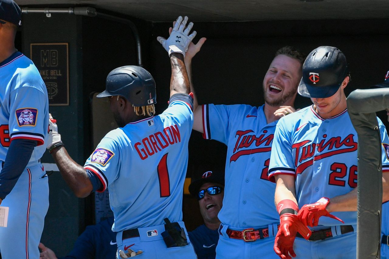 Minnesota Twins third base coach Tommy Watkins high-fives team