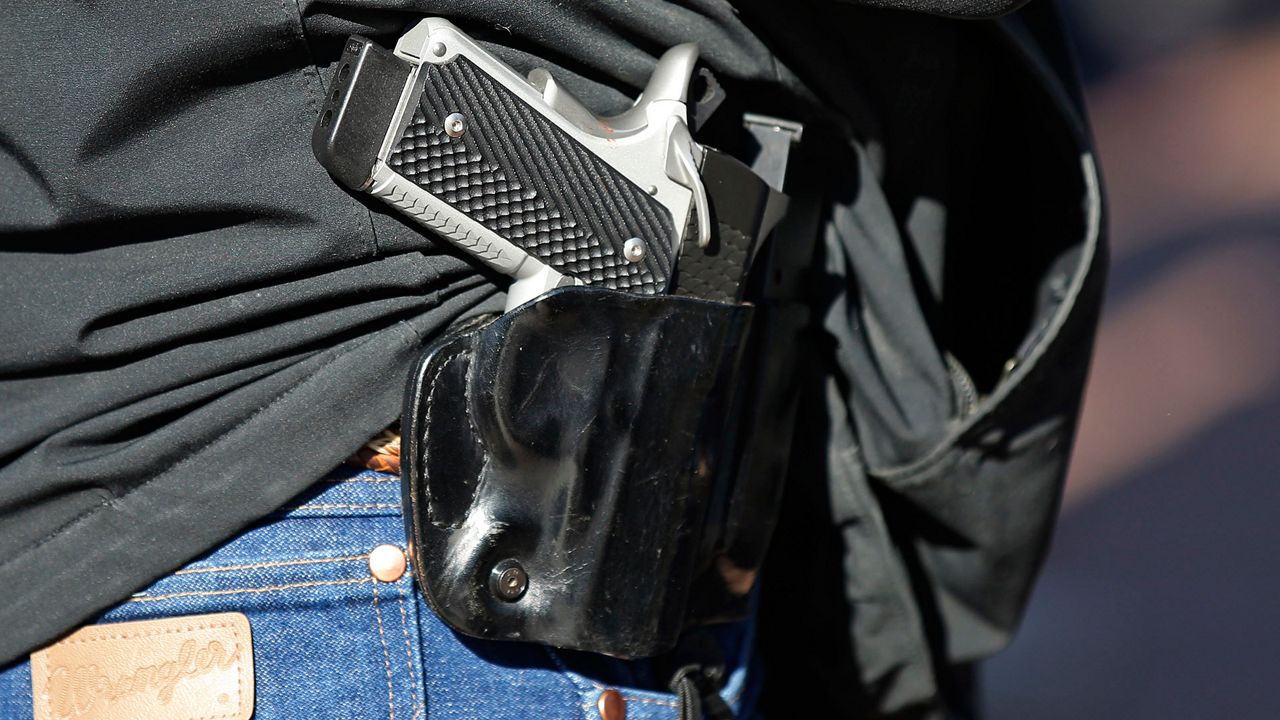 Gun advocates attend a rally at the state Capitol to mark the start of a new law that allows most adults in Oklahoma to carry a firearm in public without a background check or training, Friday, Nov. 1, 2019, in Oklahoma City. (AP Photo/Sue Ogrocki)