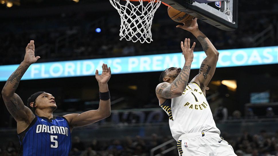 Indiana Pacers forward Obi Toppin (1) goes up for a shot as Orlando Magic forward Paolo Banchero (5) defends during the first half of an NBA basketball game, Sunday, March 10, 2024, in Orlando, Fla. (AP Photo/Phelan M. Ebenhack)
