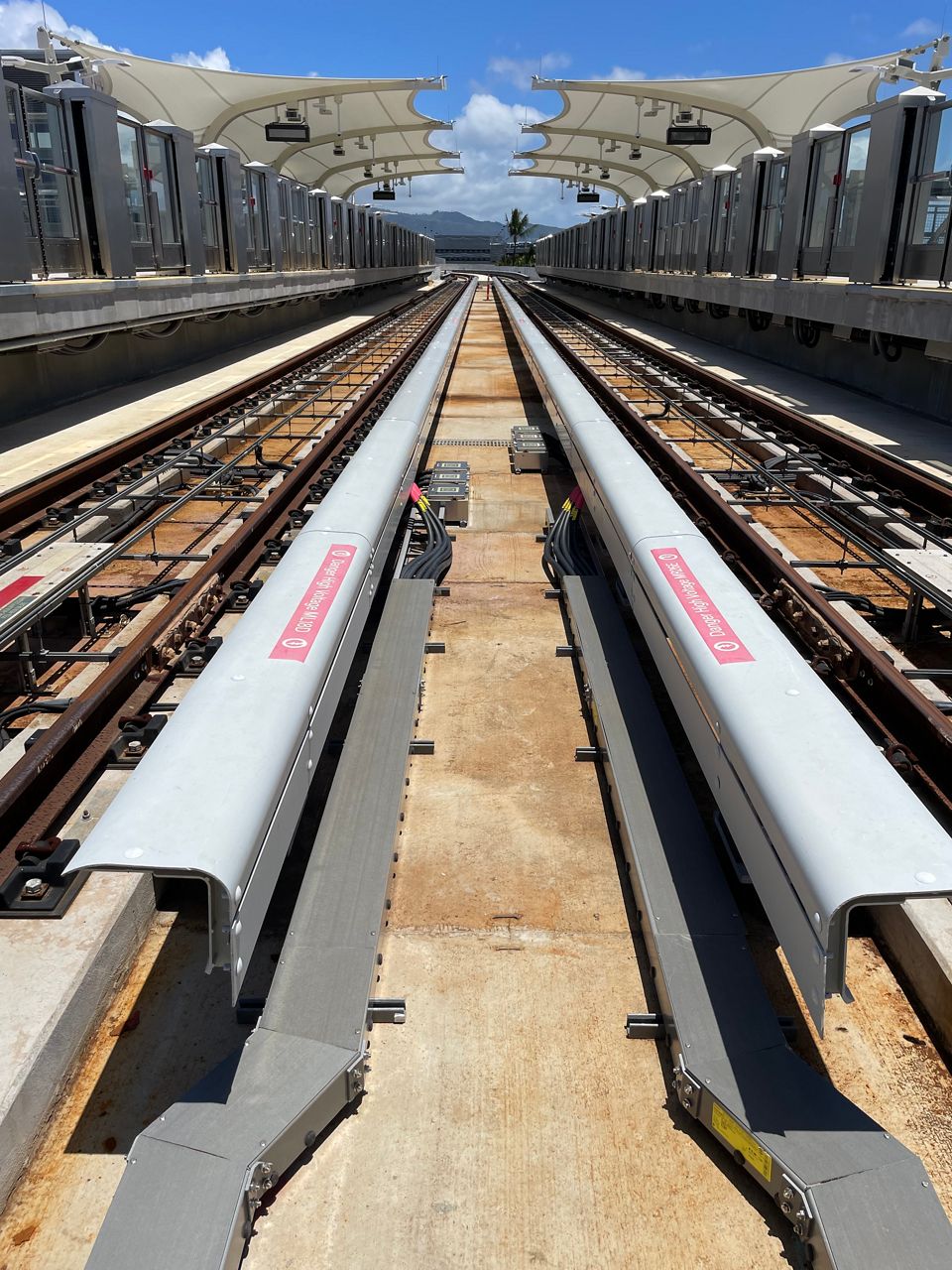 The trains’ wheels each sit on a rail (two rails) and a third rail powers the train when energized. (Photo courtesy of HART)