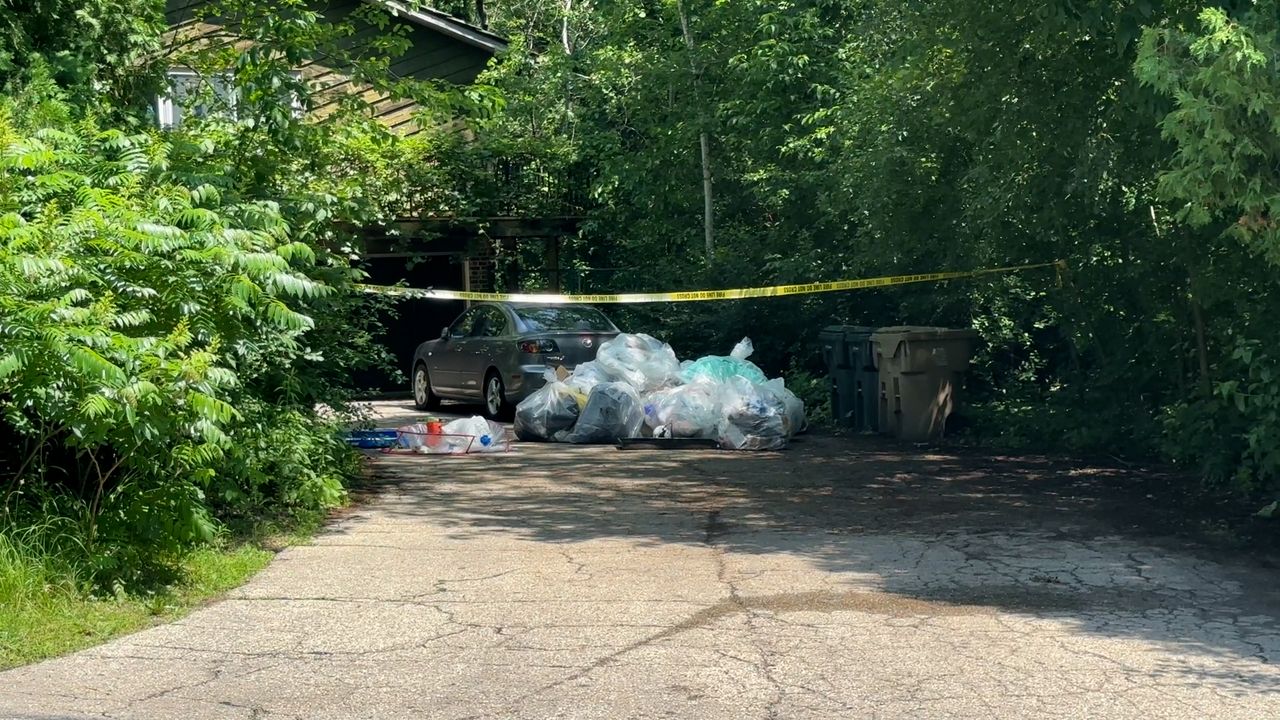 Garbage bags and caution tape were seen outside one of the homes connected to Paul Van Duyne Thursday. (Spectrum News 1/Natalie Sopyla)