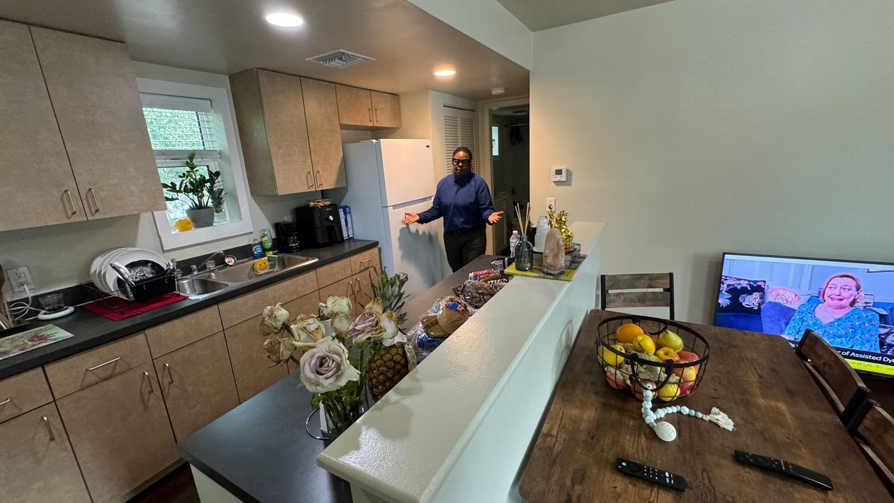 Housing Manager Anina Towns shows the inside of a new emergency shelter unit at HEP. (Spectrum Bay News 9/Melissa Eichman)