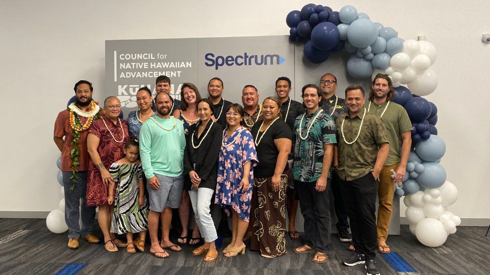 Cohort #14 of the KūHana Accelerator program celebrated their graduation on Tuesday. CNHA CEO Kūhiō Lewis at front right, Max Mukai, CNHA director of business development, at left. (Spectrum News/Sarah Yamanaka)