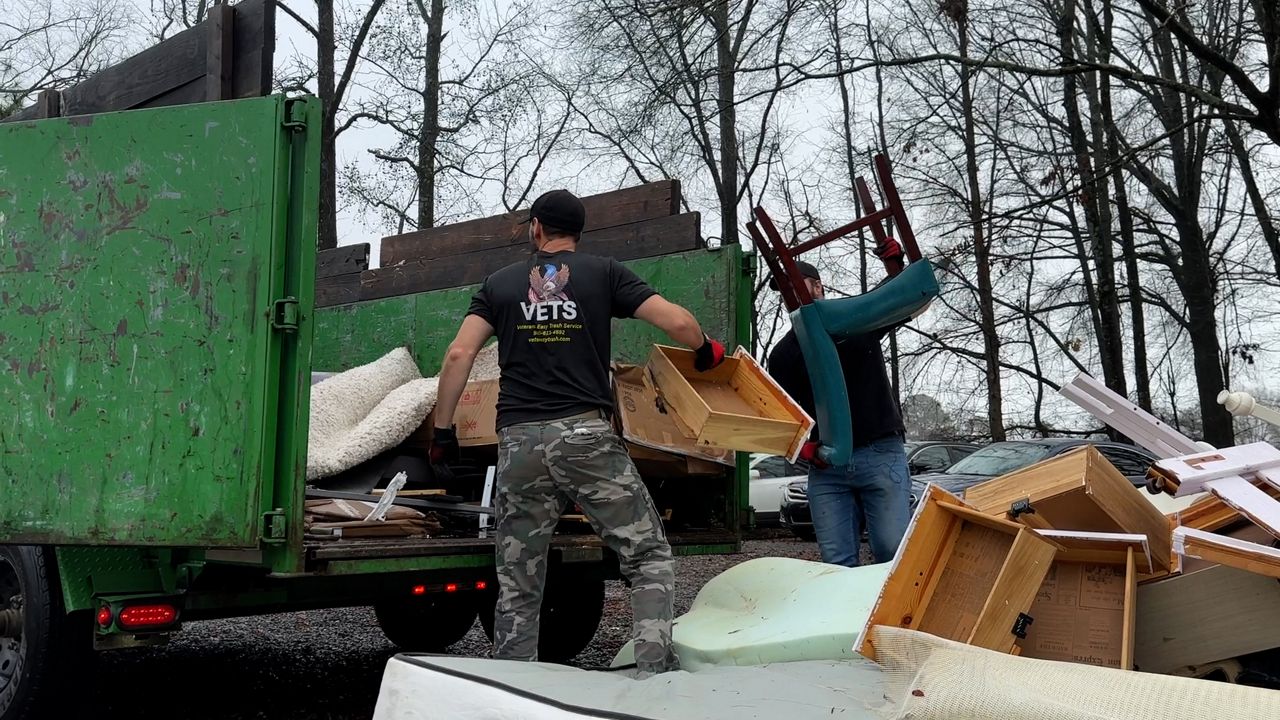 Zachary and Zane Wiley loading their dumpster 