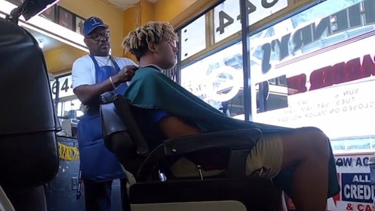 John Henry cuts hair at his barbershop in the Parramore community (Spectrum News/Curtis McCloud)