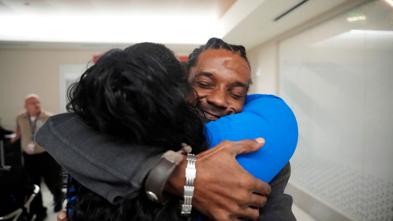 Valerie Laveus greets her brother Reginald Malherbe Daniel as he arrives for the first time to the United States from Haiti at Fort Lauderdale-Hollywood International Airport, in Fort Lauderdale, Fla., Wednesday, Aug. 9, 2023. (AP Photo/Jim Rassol)