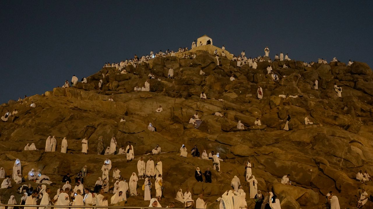 Muslim pilgrims gather at top of the rocky hill known as the Mountain of Mercy, on the Plain of Arafat, during the annual Hajj pilgrimage, near the holy city of Mecca, Saudi Arabia, Saturday, June 15, 2024. (AP Photo/Rafiq Maqbool)