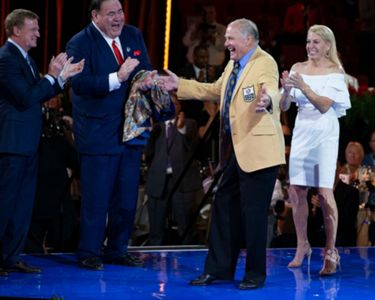 Jerry Kramer stands with his bust after his enshrinement into the