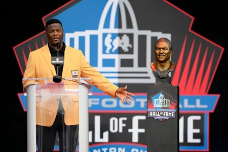 Former NFL player Tony Boselli, right, and presenter Mark Brunell pose with  his bust during an induction ceremony at the Pro Football Hall of Fame in  Canton, Ohio, Saturday, Aug. 6, 2022. (