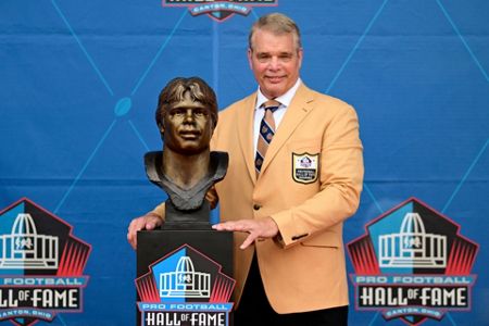 Dan Marino with his bust after his induction into the Pro Football