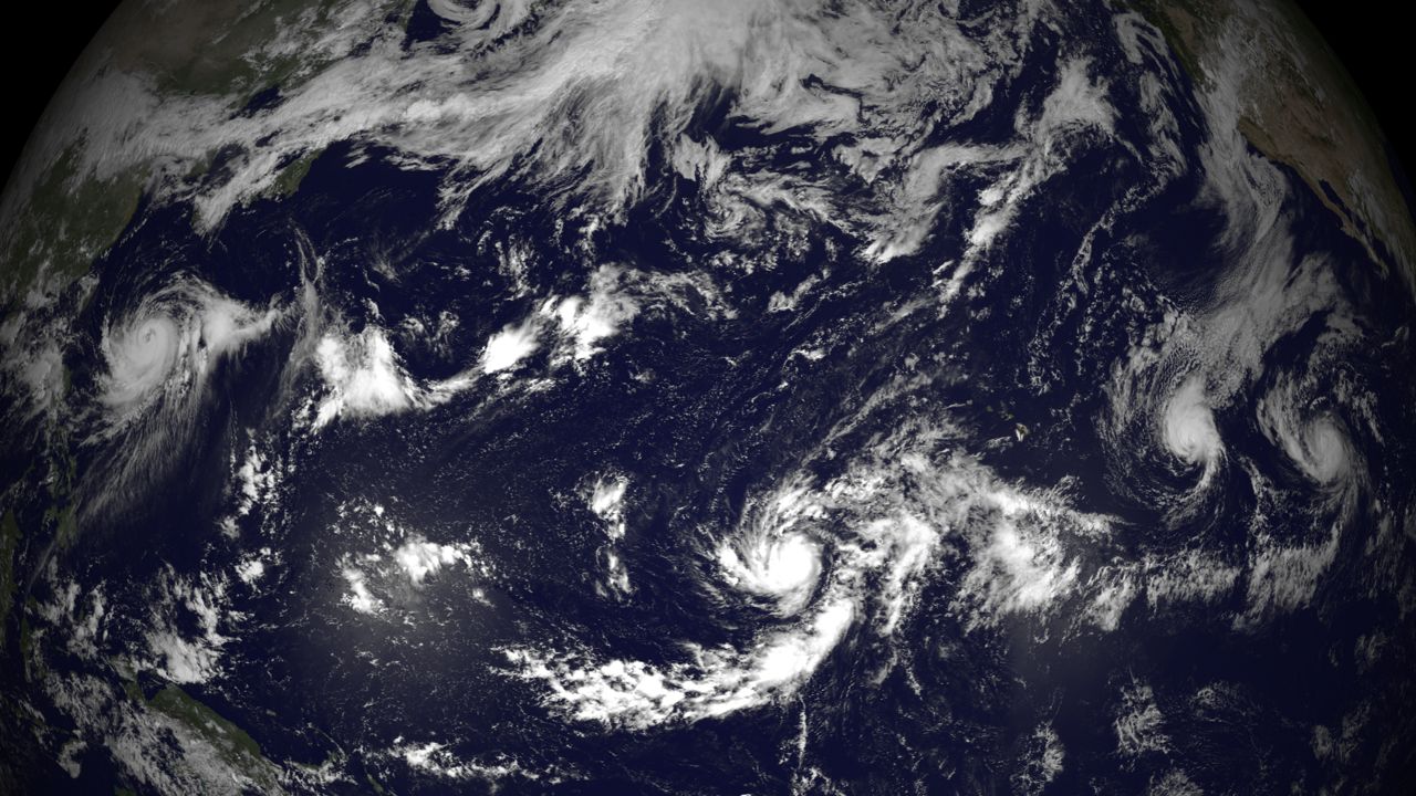 Shown from left to right are Typhoon Halong, Hurricane Genevieve, Hurricane Iselle and Hurricane Julio in this satellite image taken on Aug. 6, 2014 using visible imagery from the MTSAT-2 and GOES-15 satellites.