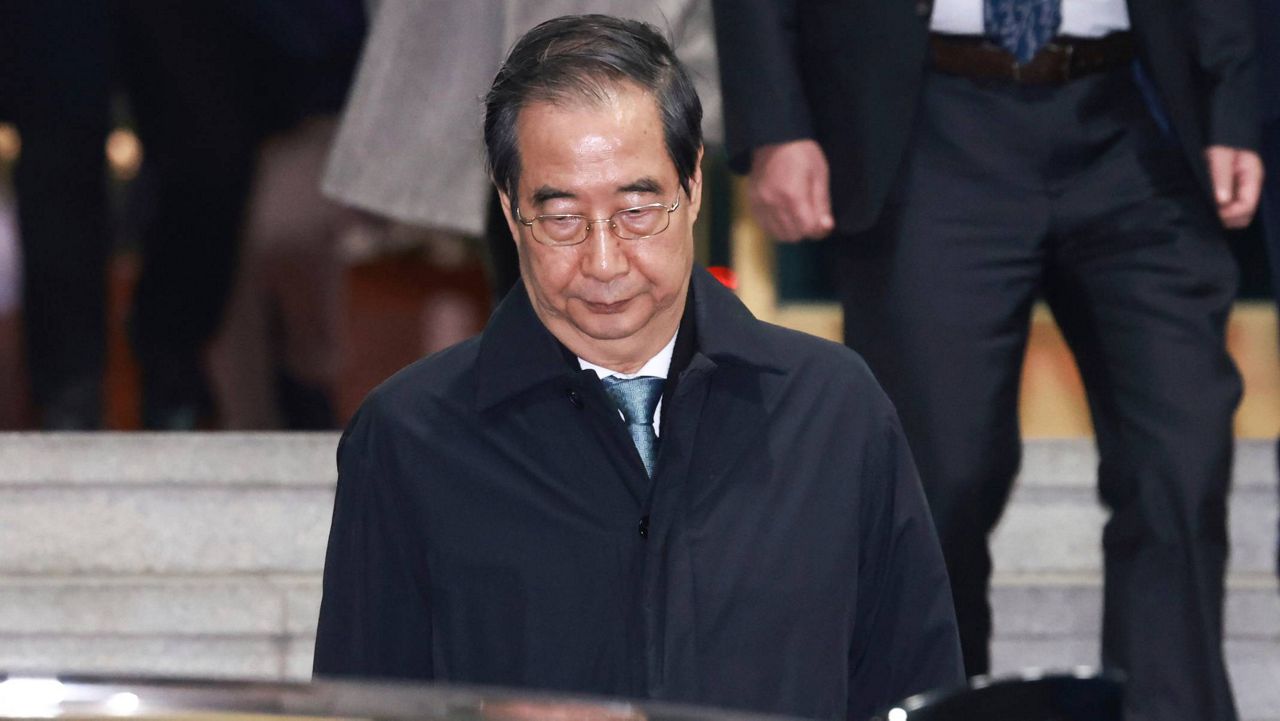 Impeached South Korean acting President Han Duck-soo leaves the government complex building in Seoul, South Korea, Friday, Dec. 27, 2024. (Hong Hae-in/Yonhap via AP)