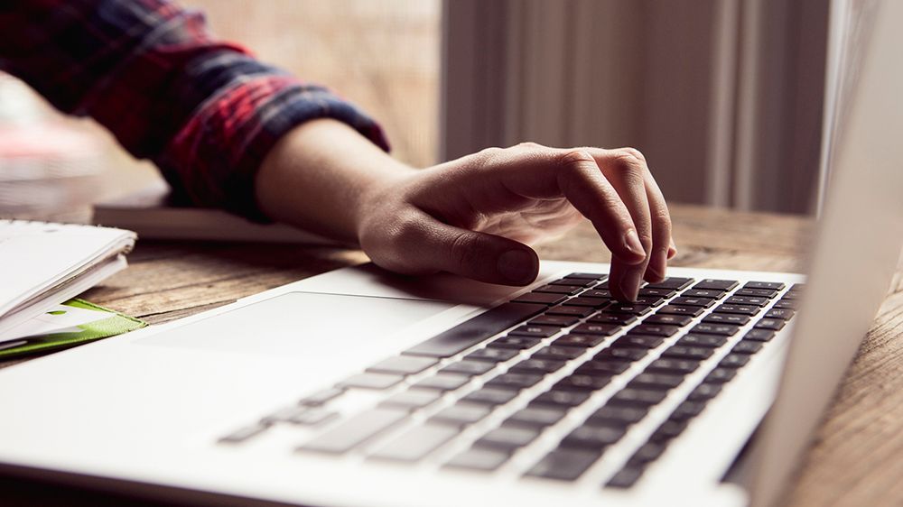 Person typing on a laptop. (Getty Images)