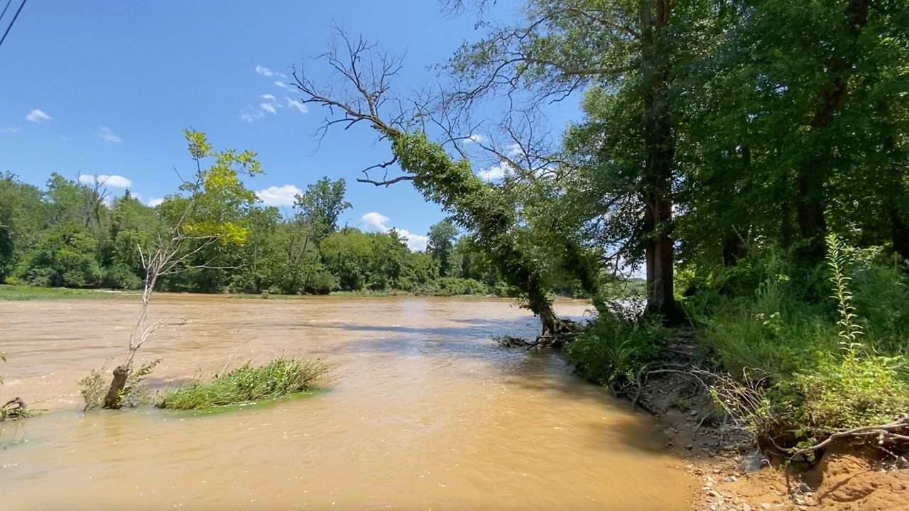 The discolored water flowing in the Haw River at the South Bynum River Access point.