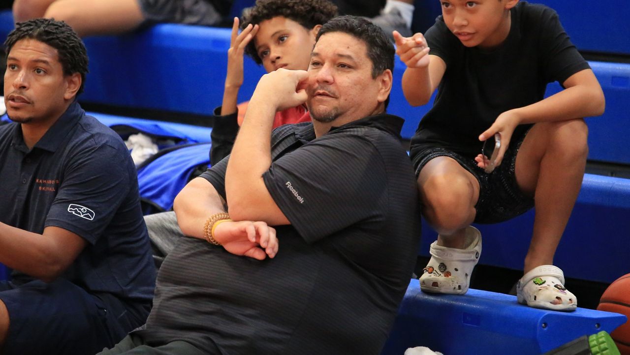 Alika Smith sat on the end of the Kalaheo High bench to watch his son Peyton during the 2024 HHSAA boys basketball playoffs at Punahou in February.