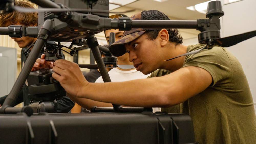 Thomas Costa attaches the LIDAR payload to the DJI Matrice 350 RTK drone. (Photo courtesy of Hawaii Community College)