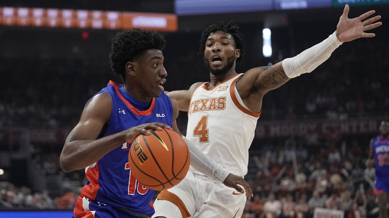 Houston Christian guard Marcus Greene drove around Texas guard Tyrese Hunter in Austin, Texas, on Dec. 9.