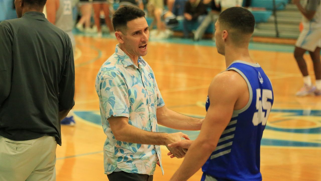 First-year head coach Jesse Nakanishi has Hawaii Pacific men's basketball in the PacWest tournament for the first time since 2017. Nakanishi shook hands with Chaminade's Isaac Amaral-Artharee on senior night Feb. 29. (Spectrum News/Brian McInnis)