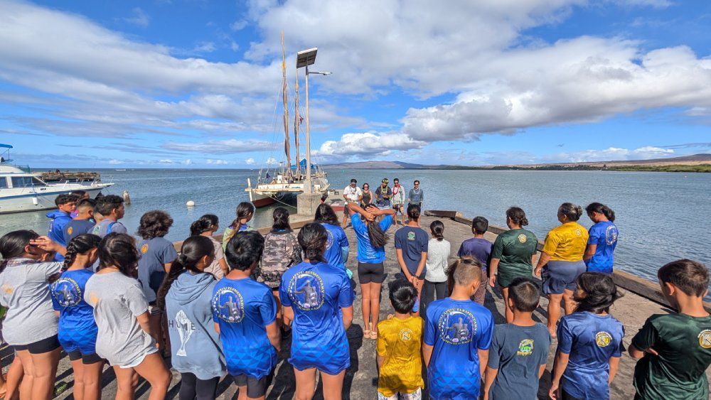 Hōkūleʻa and her crew at Kaunakakai on Molokaʻi. (Courtesy of Polynesian Voyaging Society)