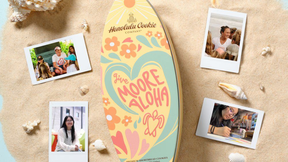 UH West Oahu student Harper Okamoto designed the Moore Aloha Surfboard Tin that launches Sunday, Sept. 8 at a meet and greet with Carissa Moore and Okamoto at Honolulu Cookie Company's Hyatt Regency Waikiki location. (Courtesy Honolulu Cookie Company)