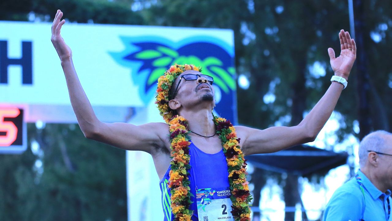 Yemane Haileselassie of Eritrea raised his arms after winning the 52nd Honolulu Marathon in 2 hours, 11 minutes and 59 seconds at Kapiolani Park on Sunday morning.