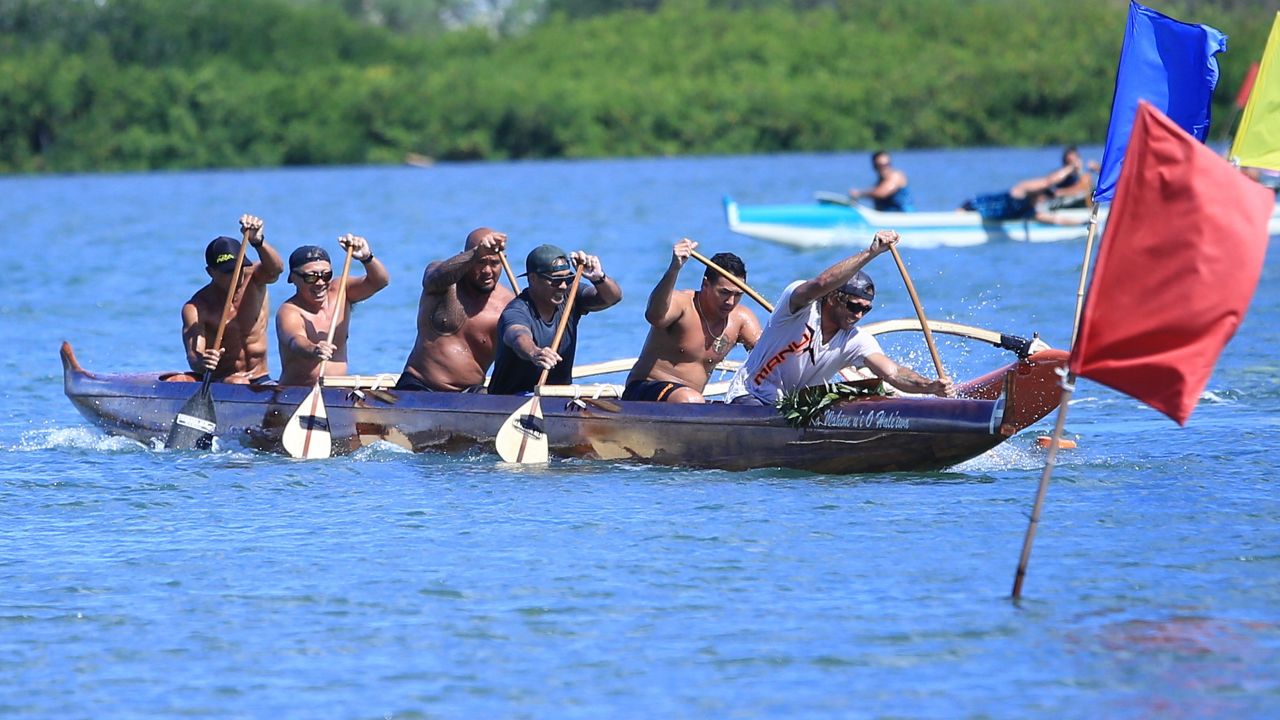 Manu O Ke Kai's men's junior crew, competing in the club's signature koa canoe, executed a turn at the second buoy in the Na Ohana O Na Hui Waa championship regatta at Keehi Lagoon on Saturday. 