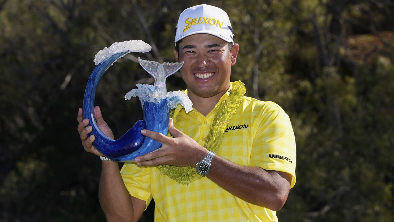 Hideki Matsuyama held The Sentry champions trophy after topping Collin Morikawa by three strokes at the Kapalua Plantation Course on Maui.