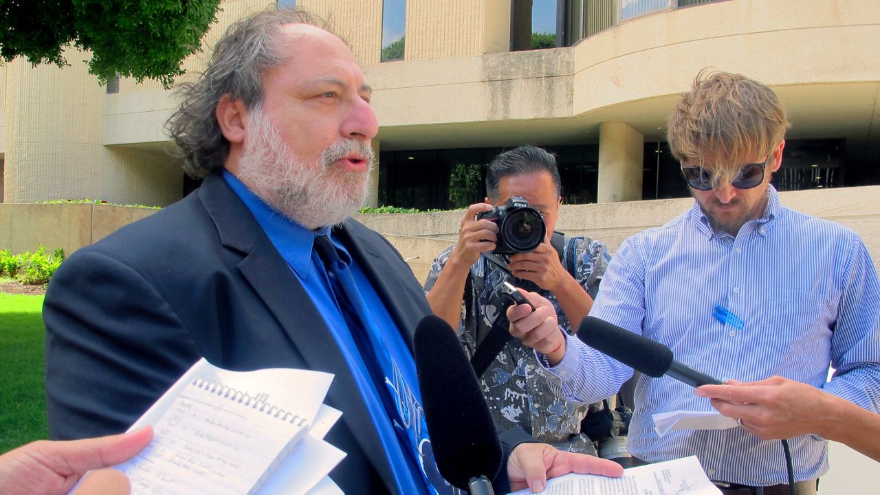 In this Dec. 16, 2014 file photo, public defender Alexander Silvert, who was instrumental in uncovering allegations that Louis and Katherine Kealoha conspired to frame a relative for a mailbox theft, speaks to reporters. (AP Photo/Jennifer Sinco Kelleher, File)