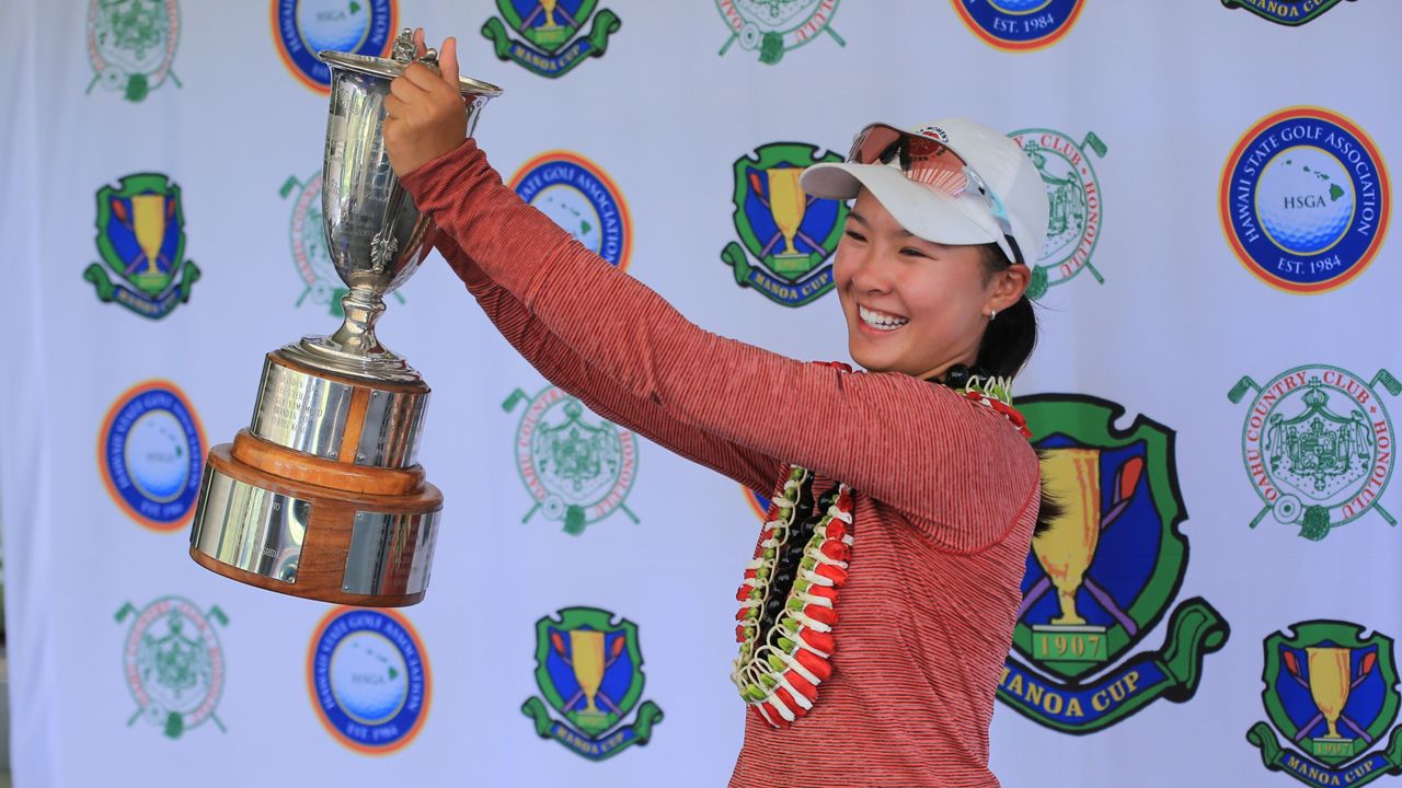 Recent Iolani School graduate Jasmine Wong hoisted the Manoa Cup trophy at Oahu Country Club after defeating Kalani High alumna Rachael Wang, 3 and 1 in the women's championship Friday.