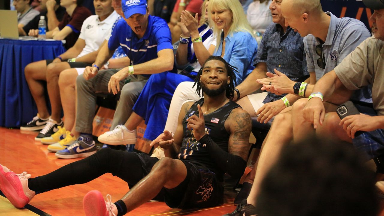 Memphis guard Tyrese Hunter hit a corner 3-pointer and slid into Tigers fans along the sideline of the Lahaina Civic Center as he got fouled for a four-point-play opportunity against No. 2 UConn. Hunter led the Tigers to a 99-97 overtime victory on Day 1 of the Maui Invitational.