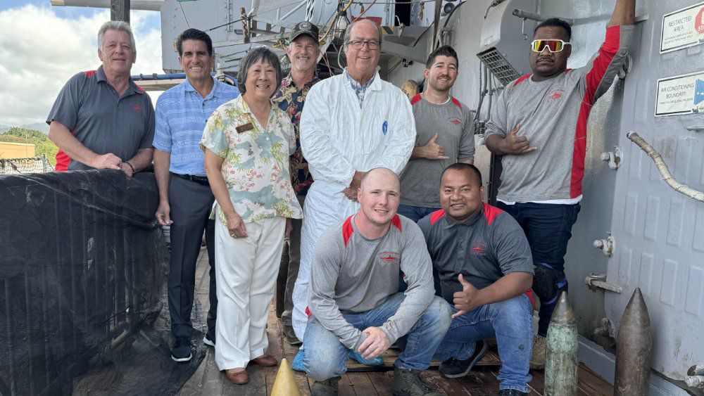 Started in 2010, the restoration of the Battleship Missouri's teak deck was finally completed last week. President and CEO of the Battleship Missouri Memorial Mike Carr stands in the center in white. (Photo courtesy of the Battleship Missouri Memorial)