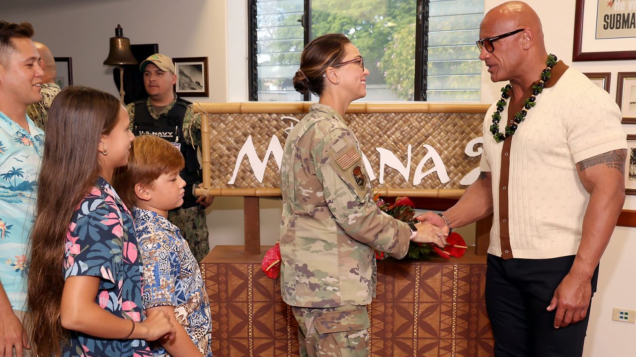 Robert Gramling (L), guests, Colonel Monica Gramling, Deputy Commander, Joint Base Pearl Harbor-Hickam and Dwayne Johnson attend the Pearl Harbor screening of "Moana 2" on November 22, 2024. (Photo by Kevin Mazur/Getty Images for Disney)